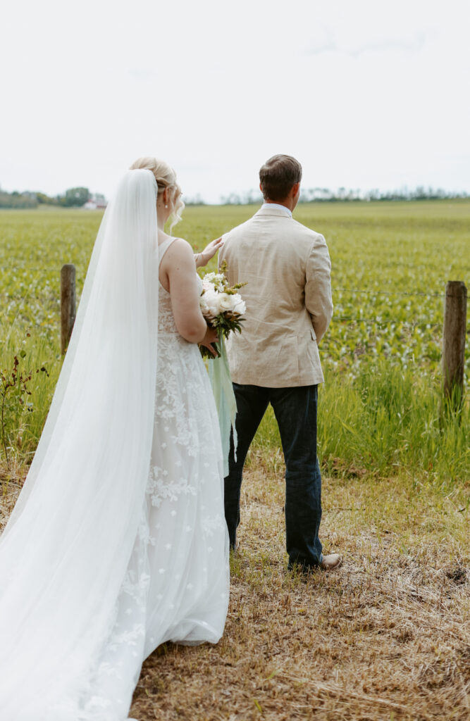 First look. Bride approaches groom