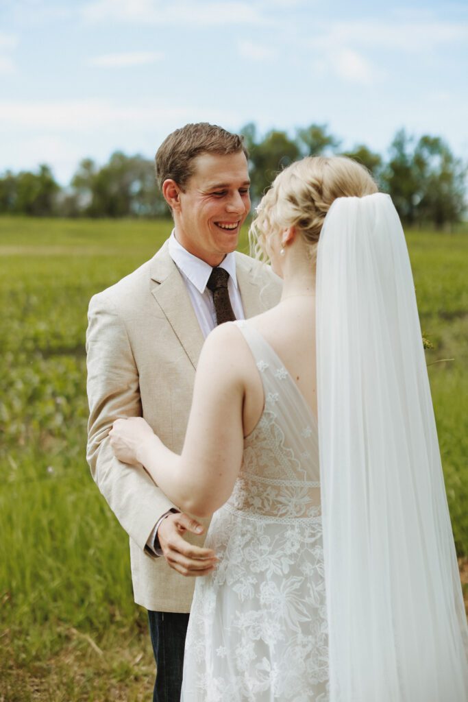 Groom hugs bride and while smiling