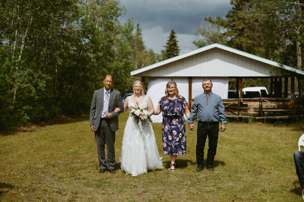 Bride walks down aisle with parents