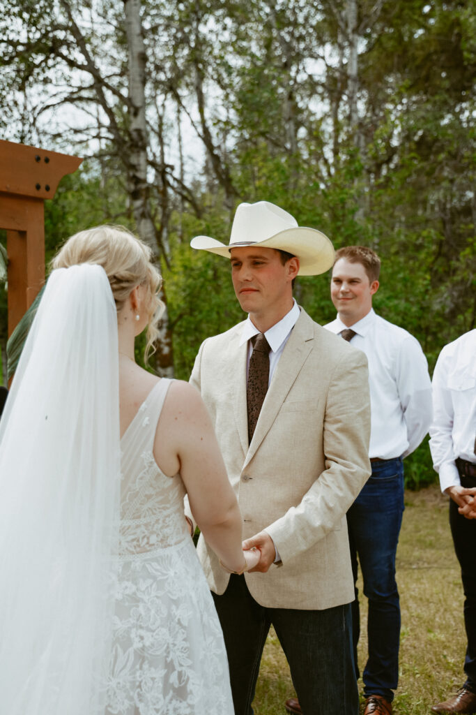bride and groom holds hands at alter
