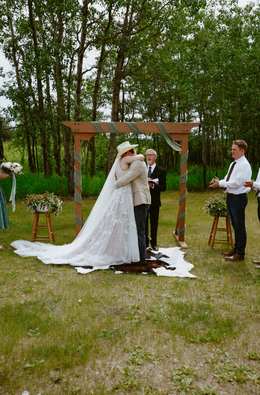 bride and groom hug at alter
