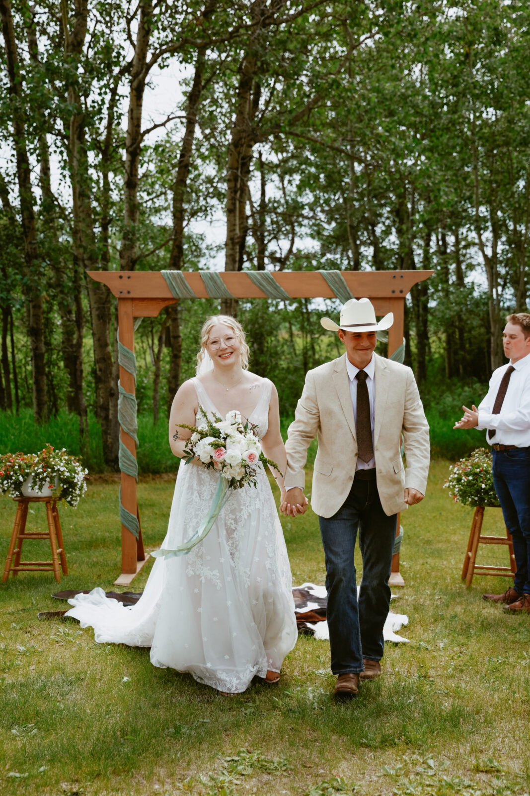 Bride and Groom walk down aisle hand in hand 