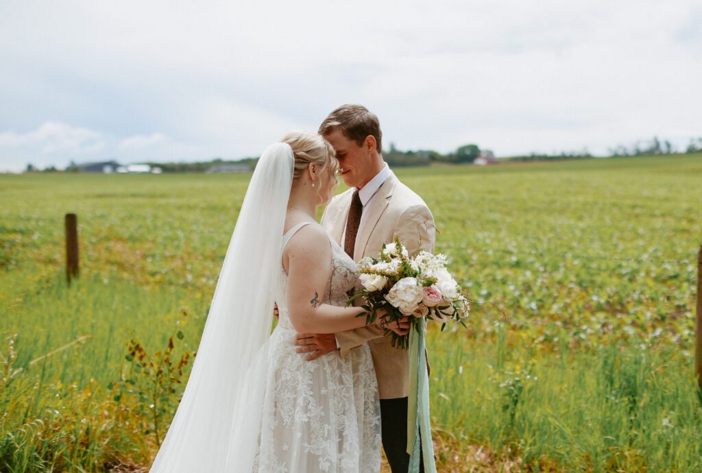 Bride and Groom stand with foreheads together.