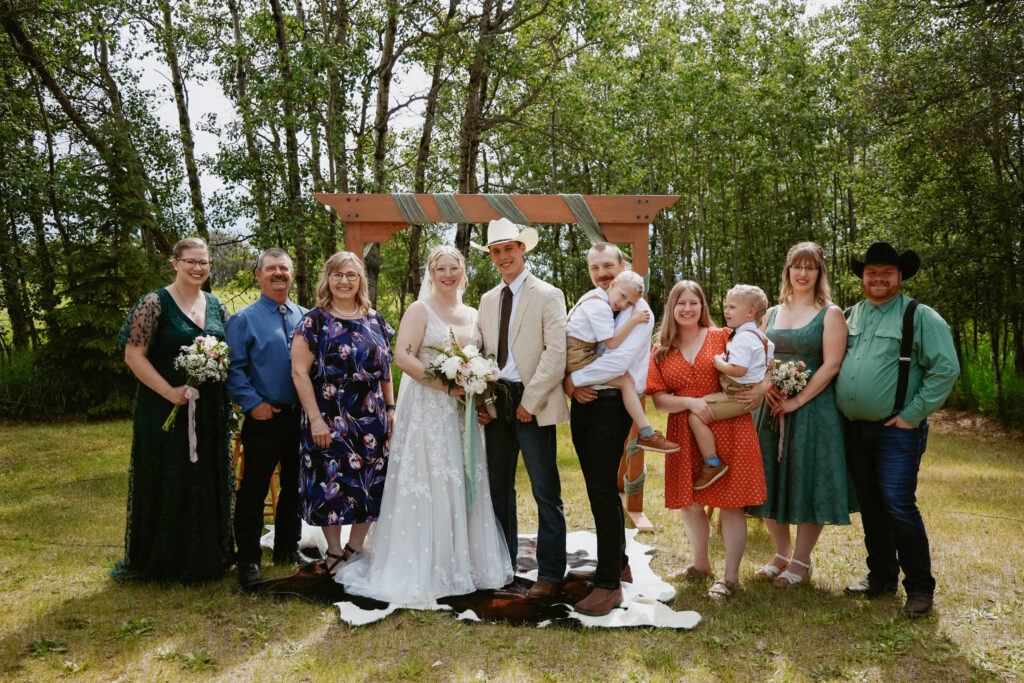 Bride and groom stand at alter with guests