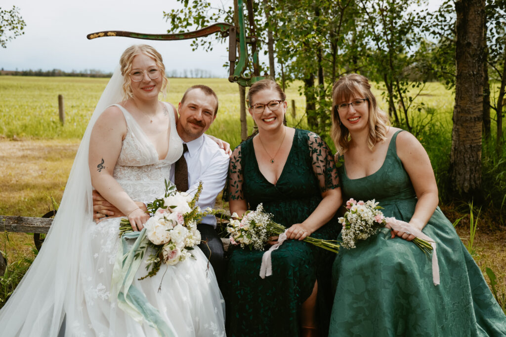 Bride sits with siblings after wedding