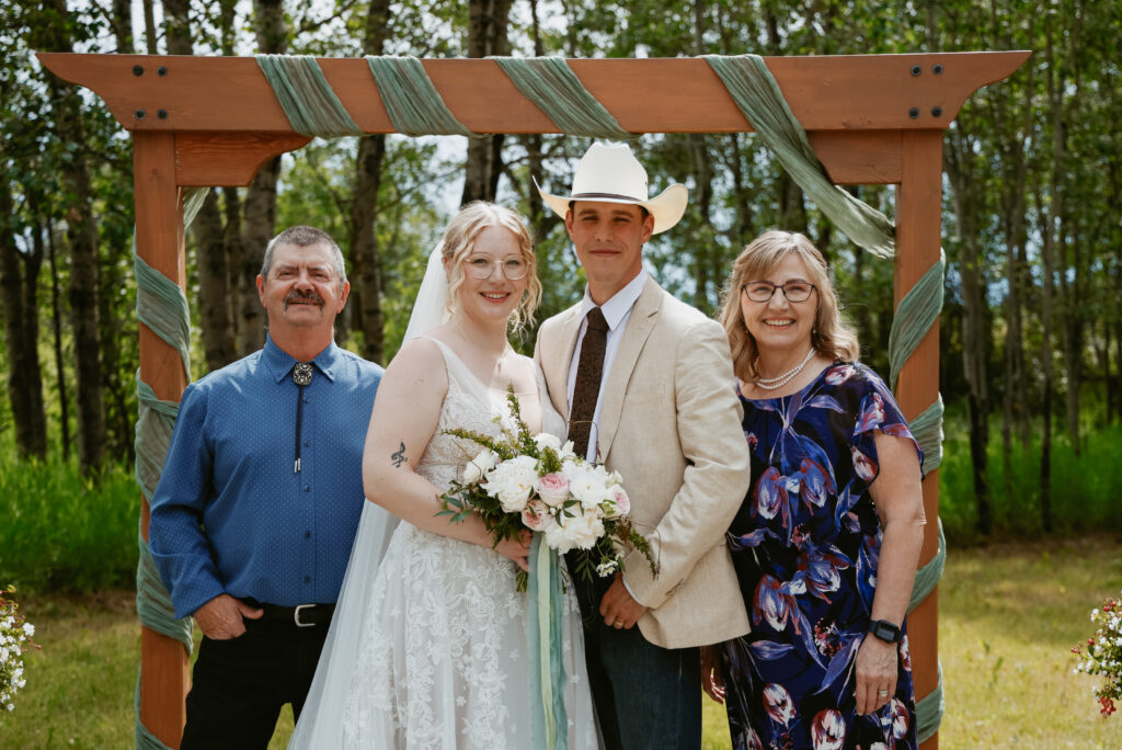 Bride and groom stand at alter with the brides parents