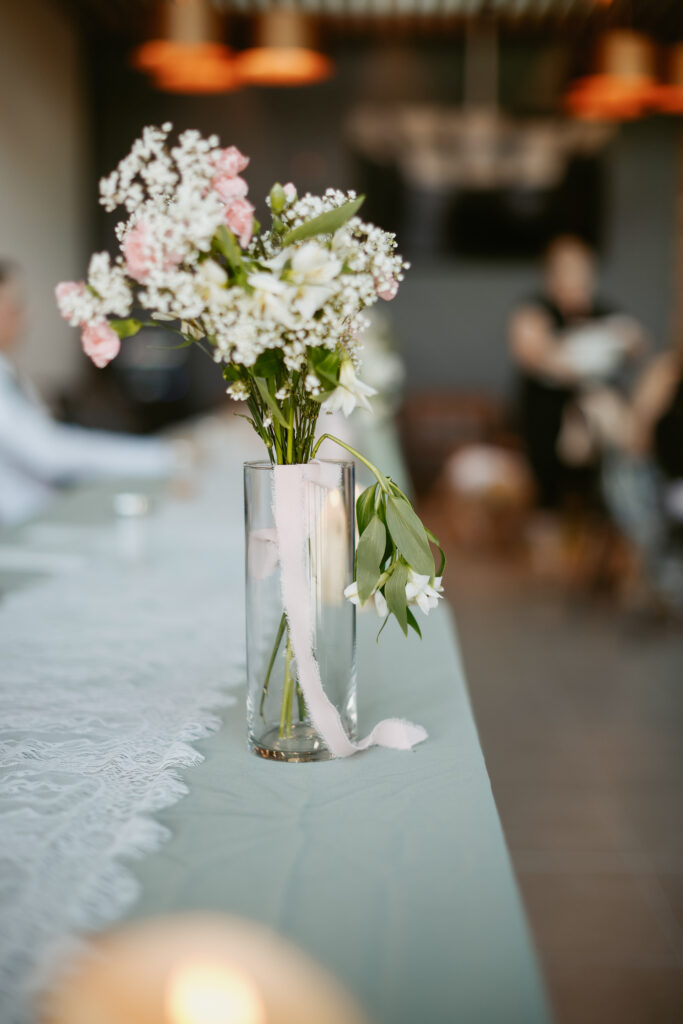 Vase of white and pink flowers.
