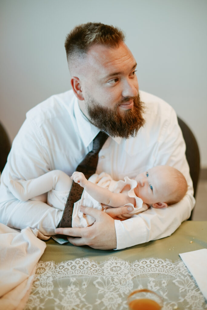 Guest with young baby at wedding reception