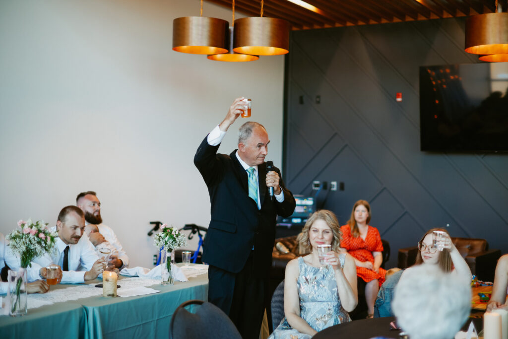 Father raises a glass. 