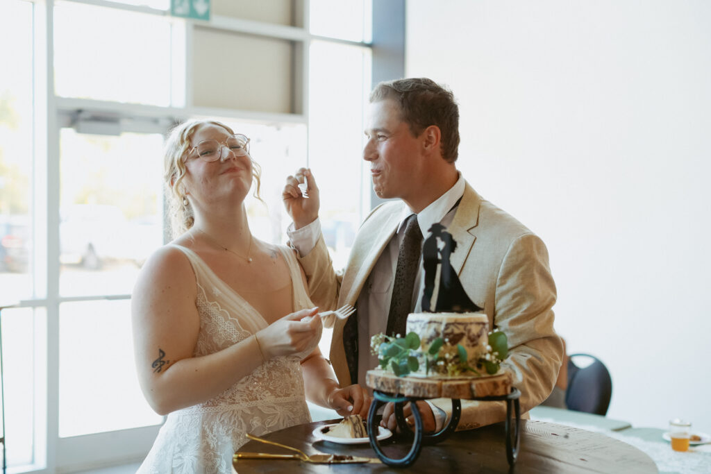 Bride and groom slice cake