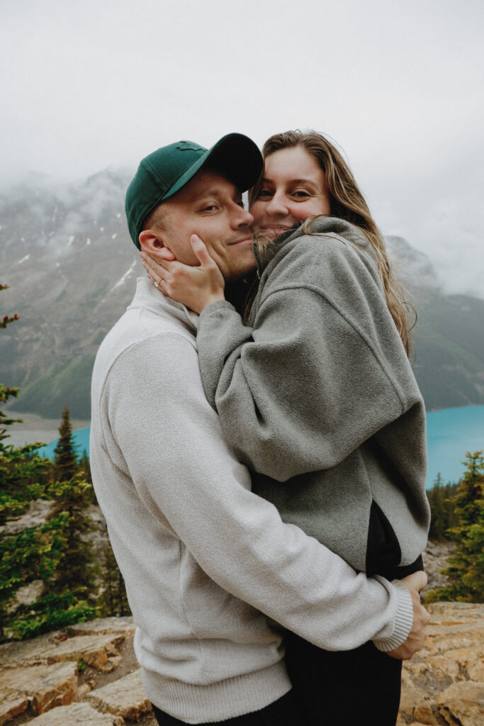 Couple hugs. Man lifts women by the bottom