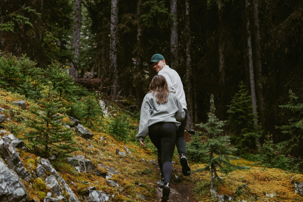 Couple walks in woods 
