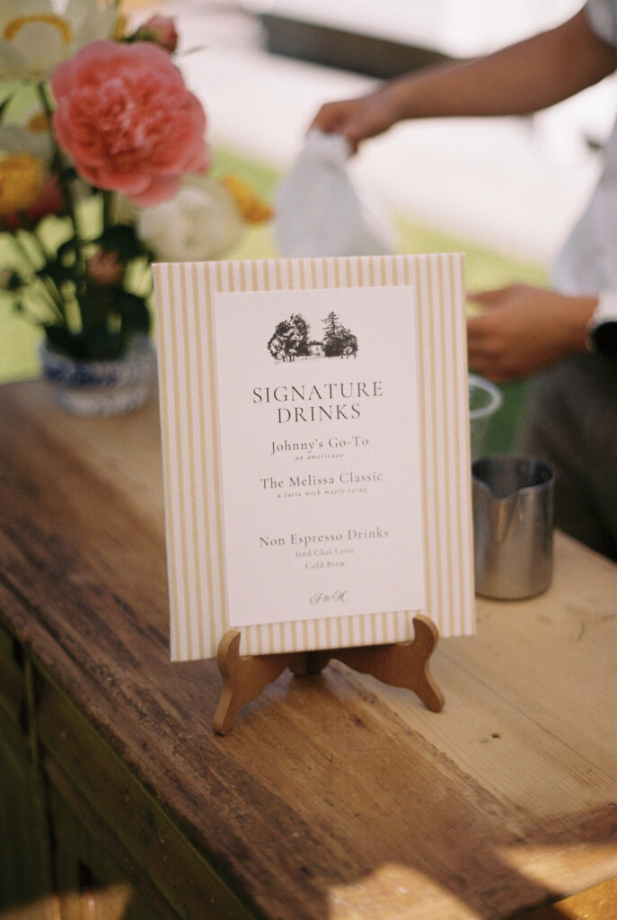 small table signage that says "Signature Drinks."