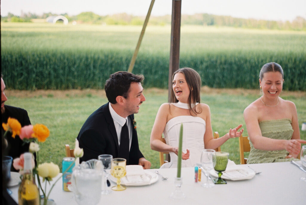 Bride and groom laugh at reception