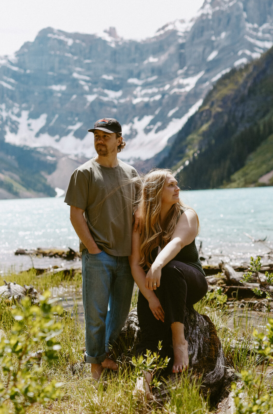 Couple during engagement photoshoot with mountains and a lake in the background