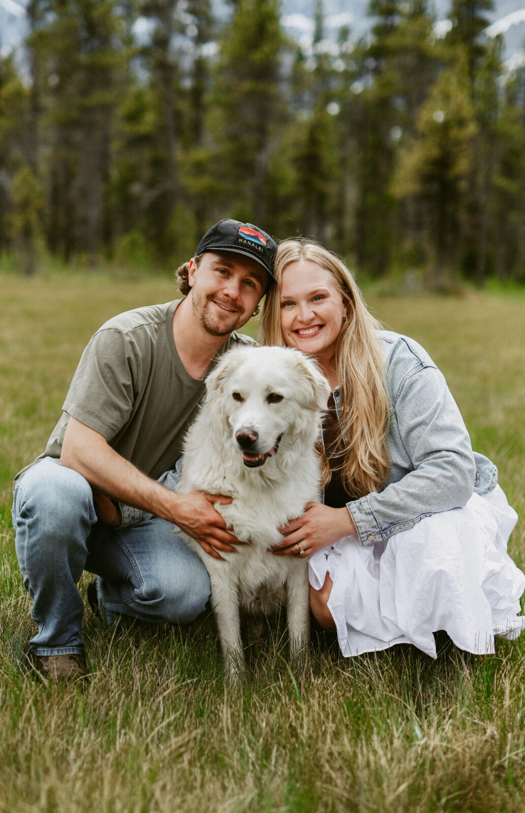 Couple sits with their dog during engagement photoshoot