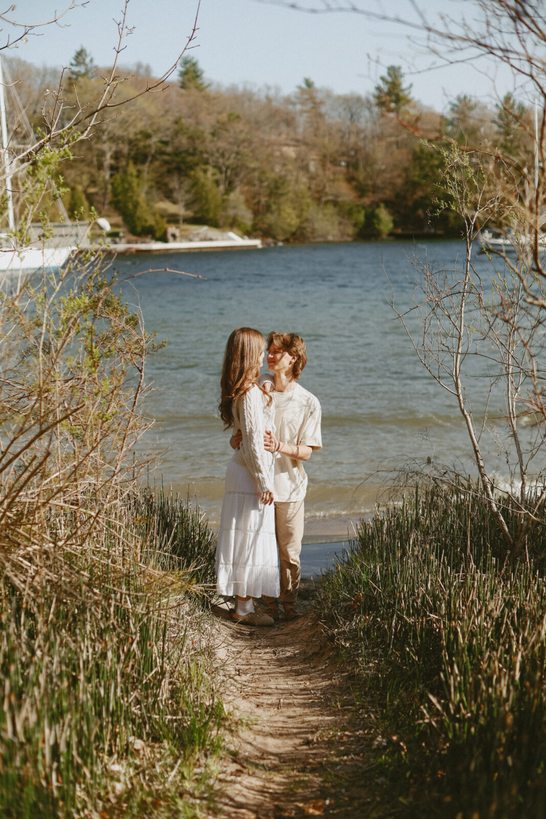 Couple kisses with Lake Ontario in the background