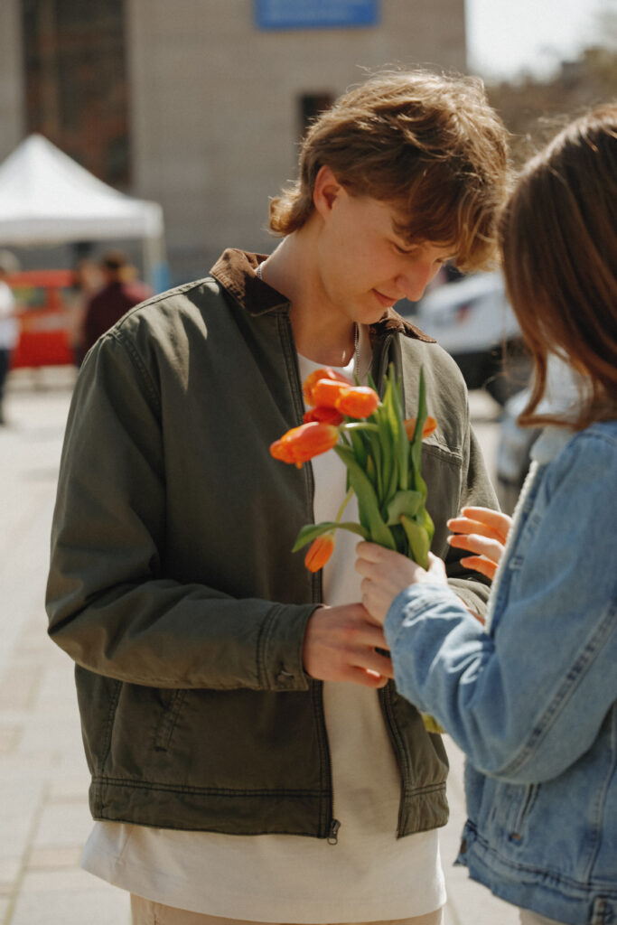 Couple holds orange tulips