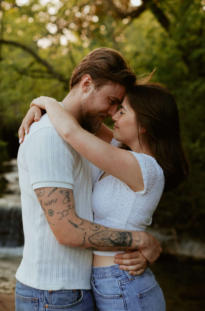 Couple hugs with their foreheads touching. 