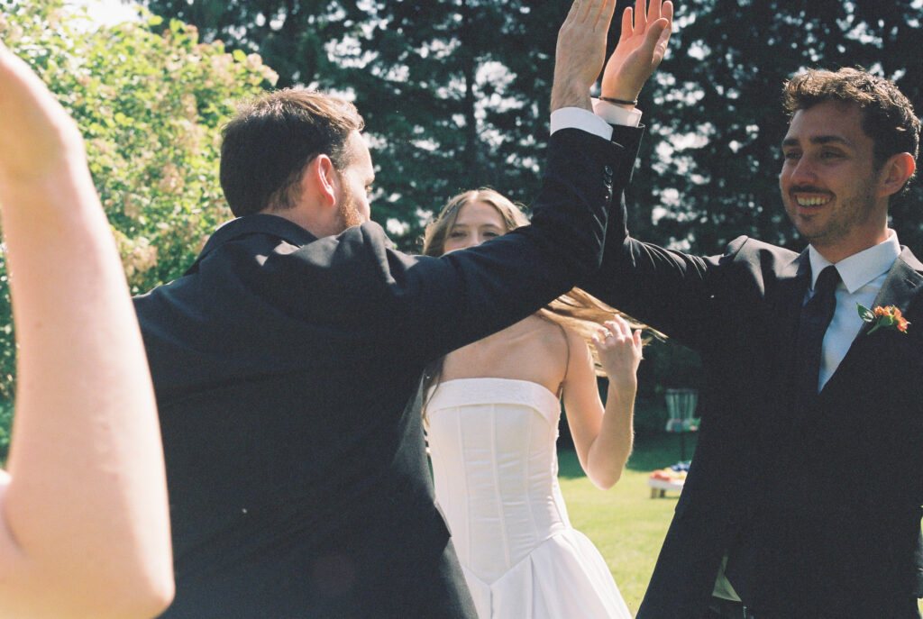 Groom and Groomsmen high-five 