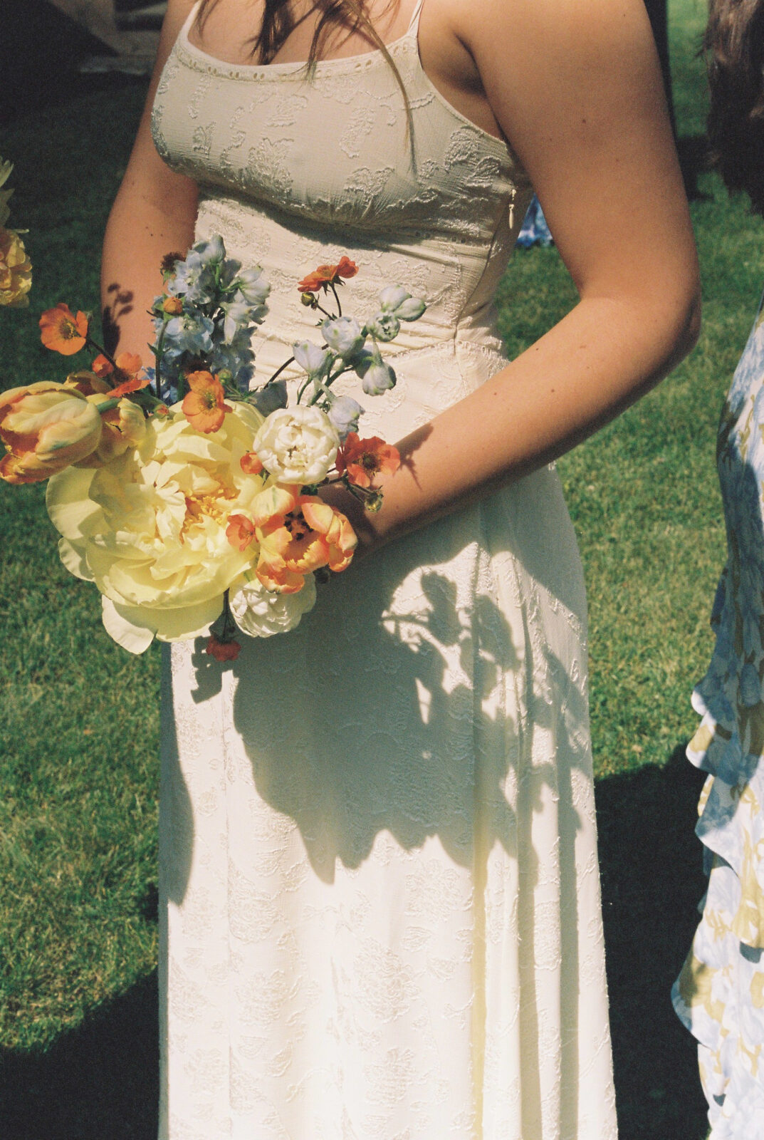 Close up flowers and bridesmaid dress