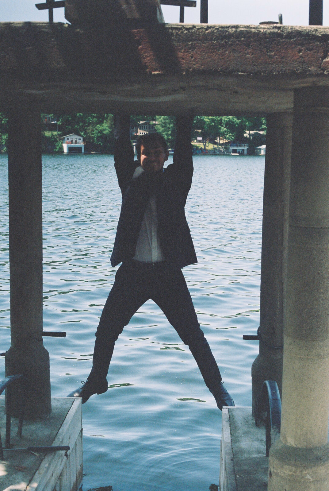Groom balances on boat house