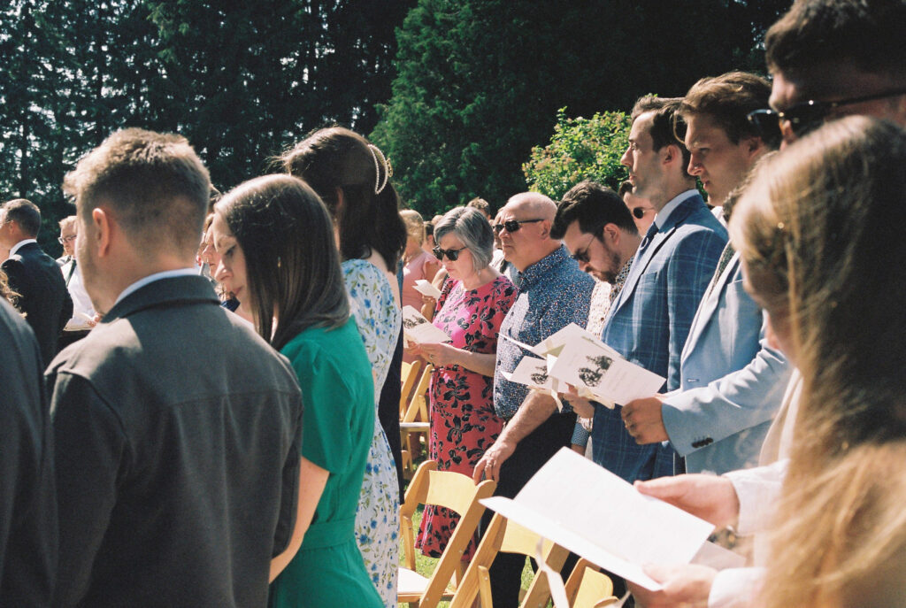 Wedding guest look at program during wedding
