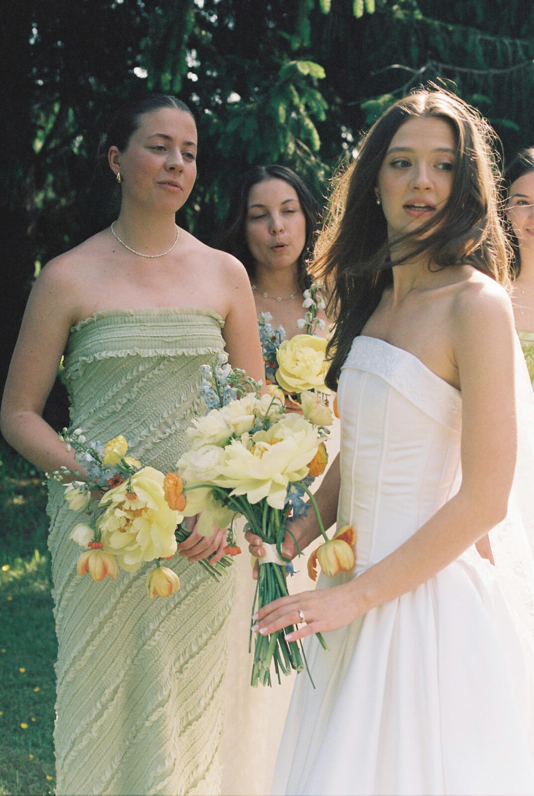 bride stands beside bridesmaid 