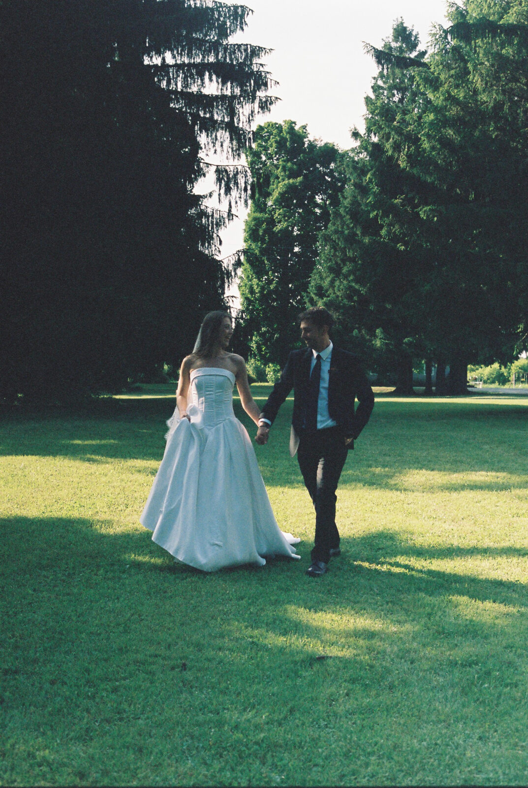 Bride and groom hold hands