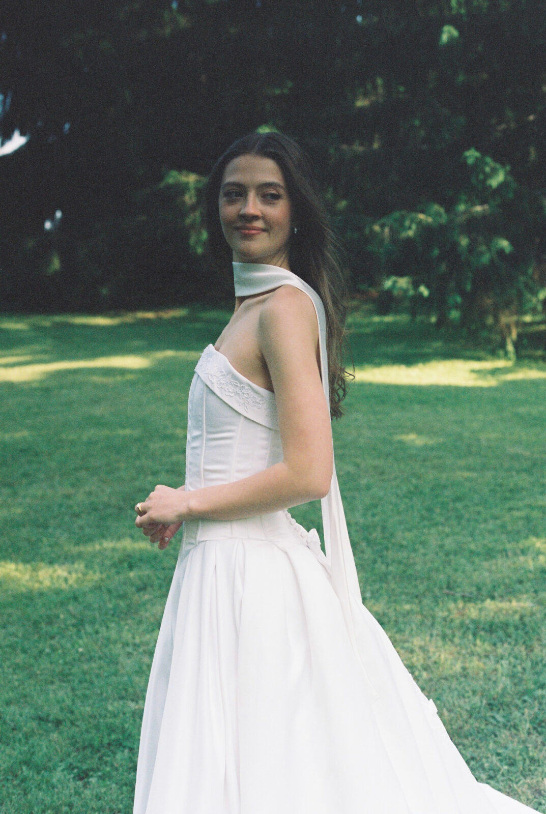 Wedding photography shoot with film. Image of the bride in backyard.