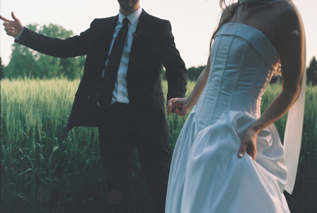 bride and groom hold hands 